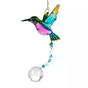 Colorful glass hummingbird ornament in blue, green, and pink hues hanging from a chain with a clear crystal ball dangling below for rainbow light prisms.