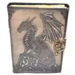 Faux leather journal with latch featuring embossed dragon perched on a rocky outcrop, textured dark cover with aged paper interior pages for grimoire and spell journaling.