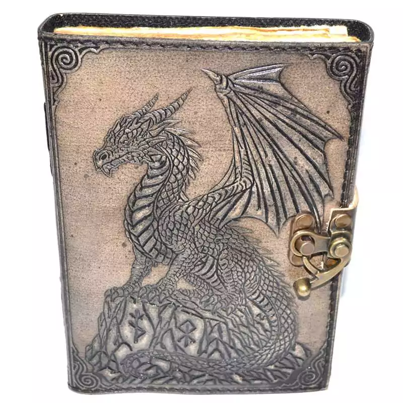 Dragon-on-Rock-aged-looking-paper-leather-w-latch-BBBL3462 Faux leather journal with latch featuring embossed dragon perched on a rocky outcrop, textured dark cover with aged paper interior pages for grimoire and spell journaling.