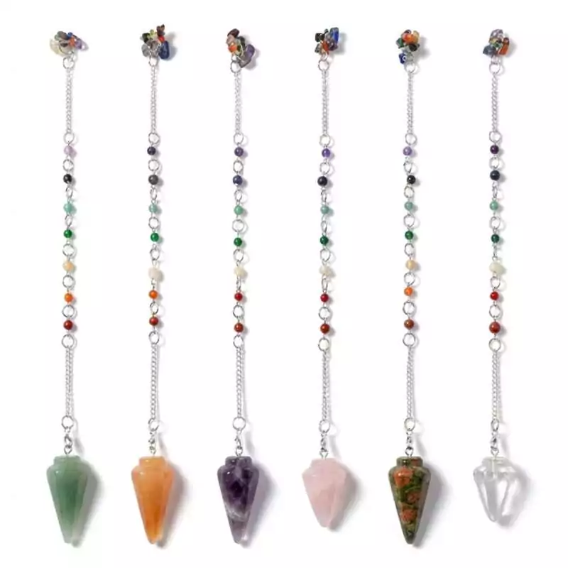 GP7VAR_Z_1 Row of six gemstone pendulums in different chakra-aligned crystal colors, each on a metal chain, chakra stone dowsing and divination tools displayed together.