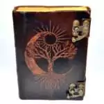 Leather-look journal with latch featuring embossed tree of life with sun and moon design on faux leather cover, aged paper grimoire Book of Shadows journal.