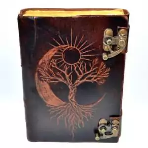 Leather-look journal with latch featuring embossed tree of life with sun and moon design on faux leather cover, aged paper grimoire Book of Shadows journal.