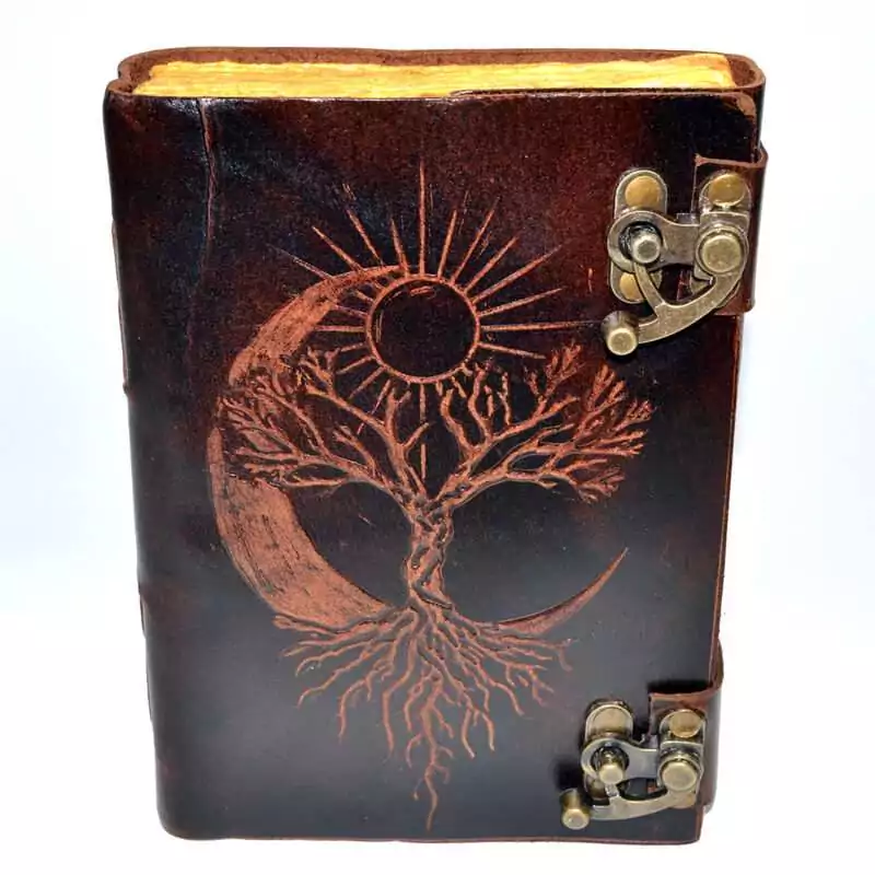 Leather-look journal with latch featuring embossed tree of life with sun and moon design on faux leather cover, aged paper grimoire Book of Shadows journal.