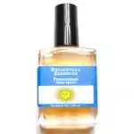 Frangipani Escential Essences fragrance oil ½ oz roll-on by Auric Blends — glass bottle with tropical floral label on white background.