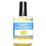 Premium Patchouli Escential Essences fragrance oil ½ oz roll-on by Auric Blends — glass bottle with earthy botanical label on white background.