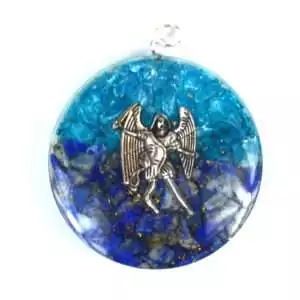 One and three quarter inch Mikael orgone pendant with blue topaz and sodalite stones set in layered resin and metal matrix on a white background