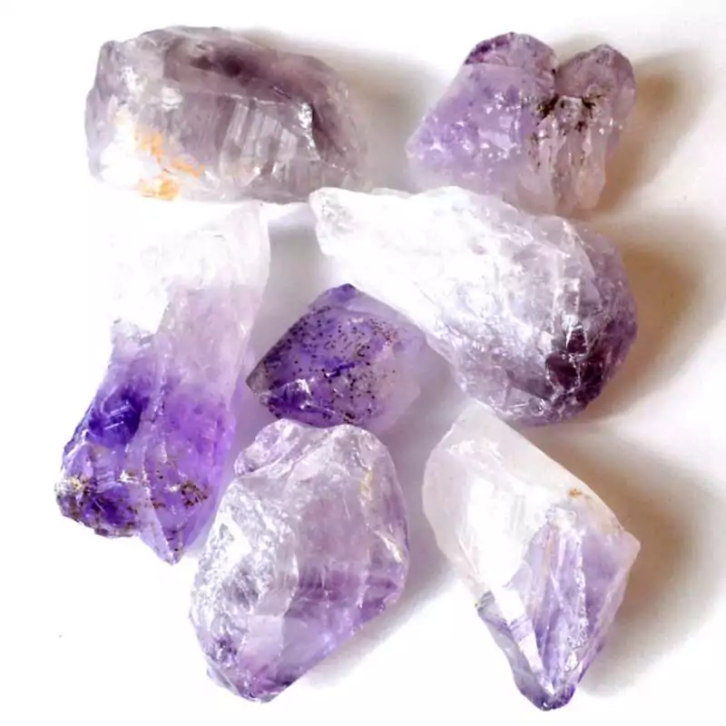 One pound of natural amethyst crystal points in deep purple hues of varying sizes arranged in a cluster showing pointed terminations and raw bases