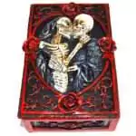 Rectangular 3.5 by 5.25 inch hinged resin box with full skeleton relief sculpted on the lid, dark aged finish, shown on plain background