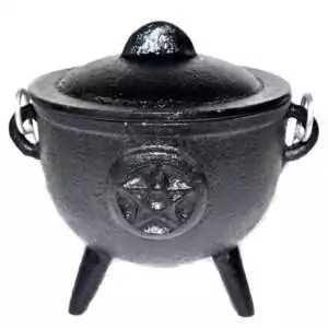 4.5-inch black cast iron cauldron with embossed pentagram star on the side, three legs and curved handles, shown on plain background