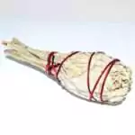Dense 4 inch white sage torch smudge bundle tightly wrapped with natural string, compact cylindrical shape on plain background