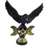 7.25 inch resin statue of a black crow in flight perched on a five-pointed pentagram star on a plain background