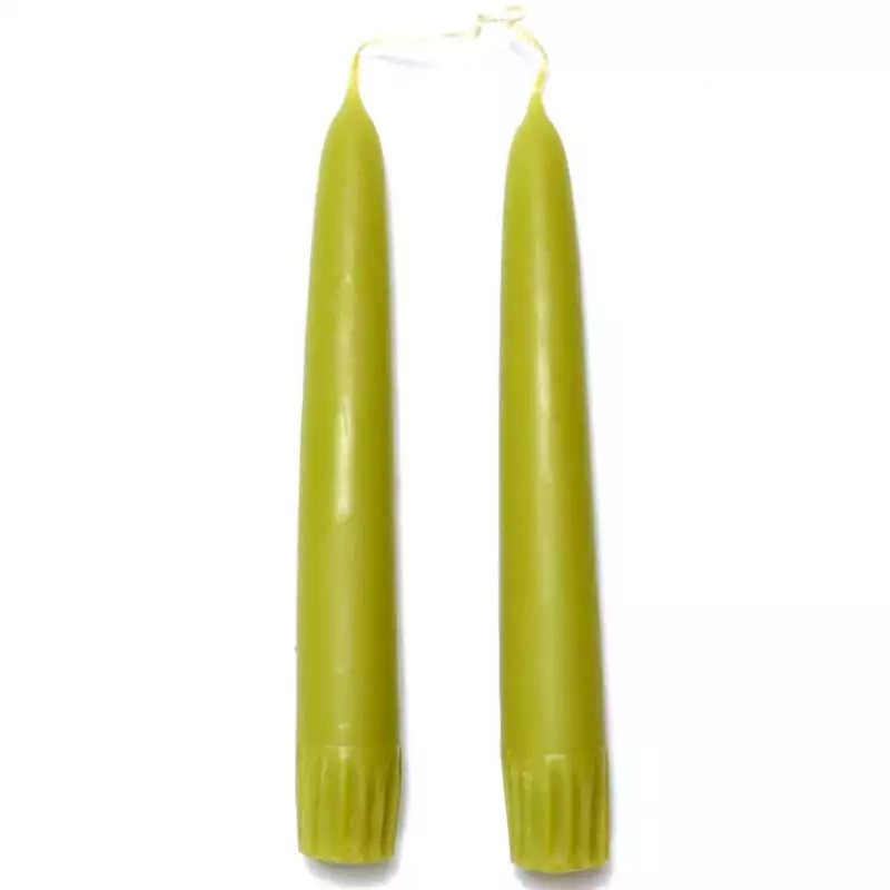 A pair of 7-inch melon green taper candles upright, displaying a warm soft green color with smooth wax and tapered pointed ends