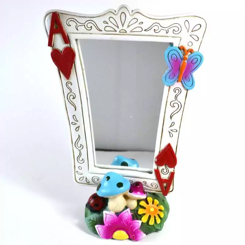 8.5 inch decorative mirror with Alice in Wonderland playing card suit motifs on the frame, shown from the front