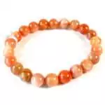 Eight millimeter peach moonstone beaded stretch bracelet with soft peachy feldspar beads showing subtle adularescent sheen on a white background