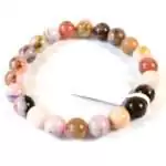 8mm pink opal beaded stretch bracelet with soft pastel-pink opaque round beads on elastic cord, shown on plain neutral background