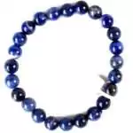 Eight millimeter sodalite beaded stretch bracelet with deep navy blue and white veined stone beads arranged in a circle on a white background