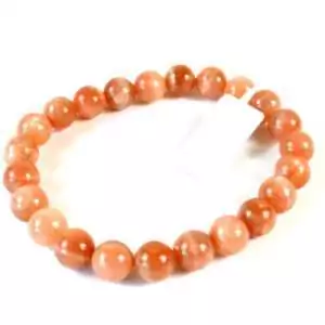 Eight millimeter sunstone beaded stretch bracelet with warm orange and golden glittering aventurescence stones on a white surface