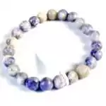 Eight millimeter Tiffany stone beaded stretch bracelet with lavender, cream, and purple swirled opalized fluorite beads on a white background