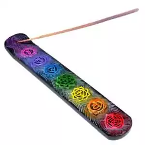 9.75-inch wooden incense stick holder painted with seven chakra symbols in rainbow colors from root to crown, lying flat on a white background