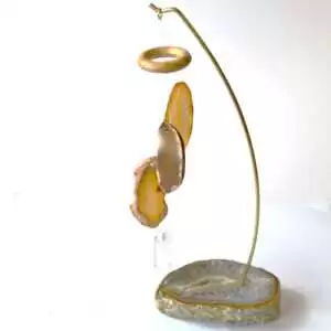 Freestanding table chime with natural banded agate slice rods hanging over a natural agate base, showing translucent stone coloring on plain background