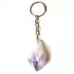 Natural amethyst crystal keychain with iridescent metallic aura plating showing purple and rainbow sheen on a white background