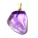Polished purple amethyst tumbled stone pendant on a cord necklace, shown against a white background.