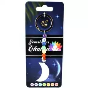 Crescent moon charm keychain with a strand of seven multicolored chakra stones on a metal ring displayed on a white background