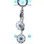 Double dreamcatcher evil eye keychain with two woven dreamcatcher charms and blue nazar bead on a metal split ring against a white background