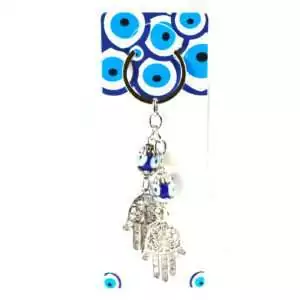 Double Hand of Fatima evil eye keychain with two hamsa charms and a blue nazar evil eye bead on a metal ring displayed on a white background