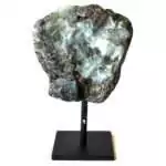 Raw natural emerald crystal mounted on a matte black display stand, showing green mineral cluster with visible crystalline structure on a neutral background