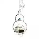 Faceted clear quartz pendulum with a lapis lazuli accent bead on a metal chain, showing deep blue lapis and transparent quartz against a white background