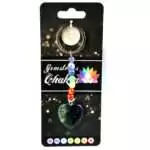 Heart-shaped charm keychain with a strand of seven small multicolored chakra crystal stones on a metal ring against a white background