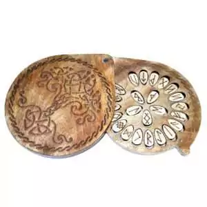 Set of 25 wooden Elder Futhark rune tiles displayed beside a decorative tree-motif carved wooden storage box