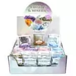 Set of 32 assorted natural gemstone and crystal mineral specimens arranged in rows, showing a variety of shapes, colors, and mineral types on a flat display surface