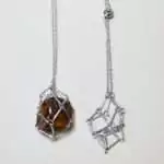 Set of four 24-inch stainless steel chain necklaces each with an open wire stone cage pendant displayed on a white background