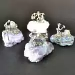 Set of 4 small miner figurines each mounted on different natural gemstone bases including varied mineral colors of purple, green, and earth tones