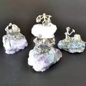 Set of 4 small miner figurines each mounted on different natural gemstone bases including varied mineral colors of purple, green, and earth tones