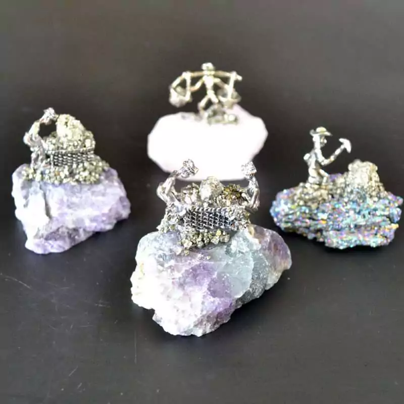 set-of-4-Miner-on-Mixed-stones-GG165 Set of 4 small miner figurines each mounted on different natural gemstone bases including varied mineral colors of purple, green, and earth tones