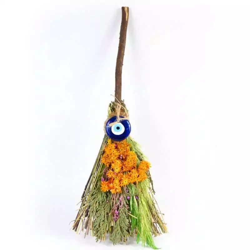 Eleven-inch ritual herb besom broom with bundled dried herbs and blue evil eye nazar charm woven into the handle, shown against plain background