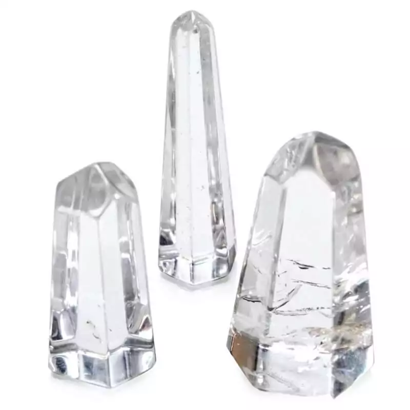 1quot-1.5quot-Quartz-obelisk-GOQUA1_Z Small polished clear quartz obelisk tower measuring 1 to 1.5 inches, showing transparent crystalline structure with a pointed tip on a white background