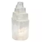 Polished white selenite iceberg-shaped carving measuring 2.5 inches, showing smooth satin spar surface with natural fibrous striations on a light background