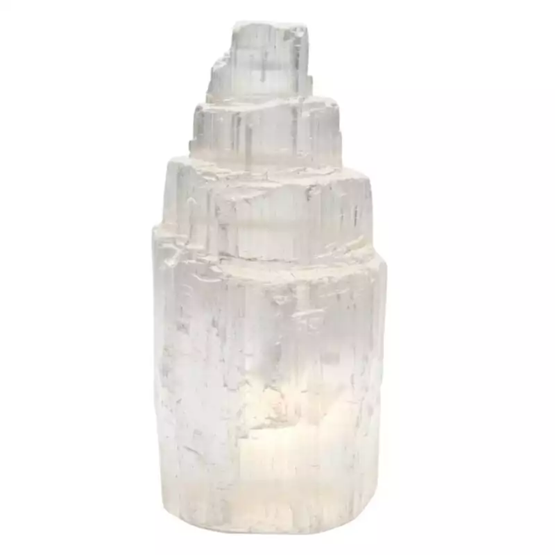 Polished white selenite iceberg-shaped carving measuring 2.5 inches, showing smooth satin spar surface with natural fibrous striations on a light background