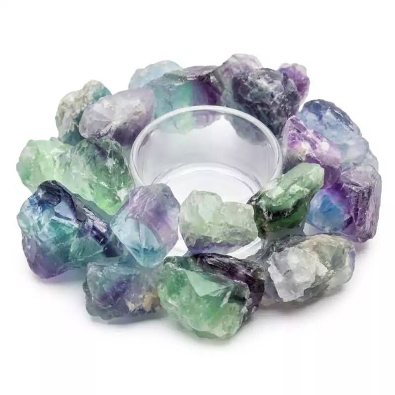 4-12quot-Fluorite-tealight-holder-CH002_Z A circular arrangement of colorful fluorite crystals in shades of green and purple surrounds a clear glass dish. The crystals are rough and unpolished, showcasing their natural beauty.
