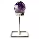 Larger natural amethyst crystal cluster with multiple deep purple points mounted on a silver-toned display stand on a white background