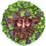 5 inch wall plaque depicting Bacchus the Roman god of wine with grape and vine motifs in relief sculpture