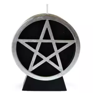 A black wax pentacle figure candle showing a five-pointed star in a circle molded onto the front face of the candle, set against a plain background