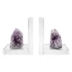 Matched pair of natural amethyst slab bookends with deep purple druzy crystal clusters, shown propping books on a plain surface