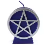 A purple wax pentacle figure candle with a five-pointed star in a circle embossed on the front face, showing deep violet-purple wax with a smooth finish