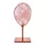 Natural pale pink rose quartz crystal specimen mounted on a warm copper-toned display stand against a white background showing soft blush mineral surface