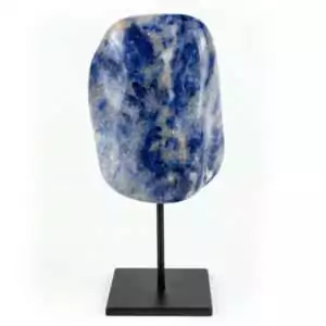Natural deep blue sodalite crystal with white calcite veining mounted on a matte black display stand against a white background